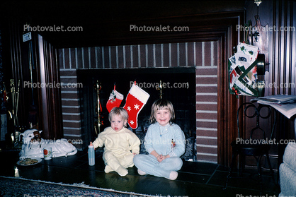 Girls, fireplace, santa stockings, 1960s