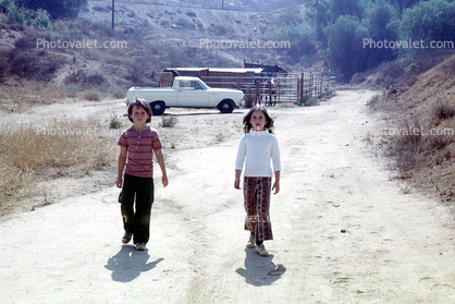 Kids walking down the street, Dirt Road, Rural, 1960s, unpaved