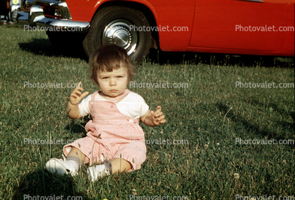 Toddler Girl Sitting on a Lawn