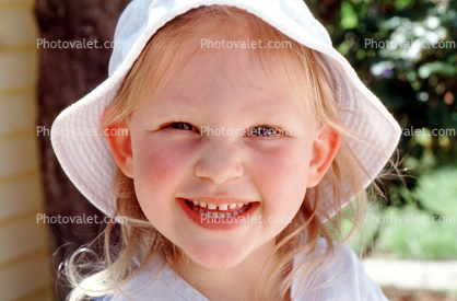 Smiling Girl wearing a hat, happy face, joy