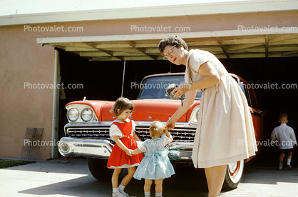 Girls, Mother, dress, glasses, 1959 Ford Fairlane, car, garage, 1950s