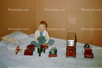 Boy and his toy cars, Jeep, tractor, PIE Express, Bed, collection, 1950s
