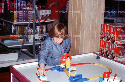 Girl playing with toy train, store