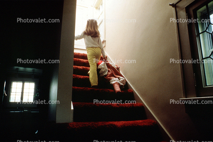 Girl walking upstairs with a Doll
