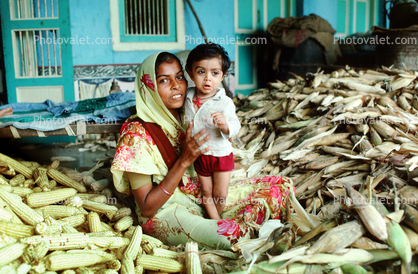 Mother and her boy, son, corn, husks, shucking corn, Gujarati, India