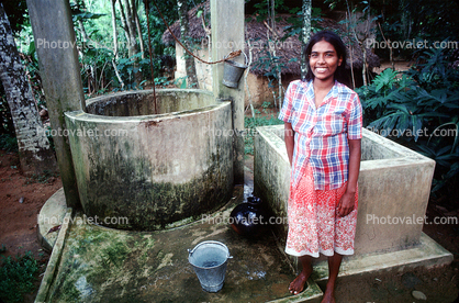 smiling girl, water well