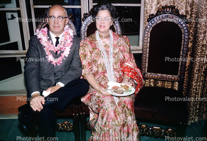 Flowery Dress, Lei, smiles, food, man, woman, glasses, October 1964, 1960s