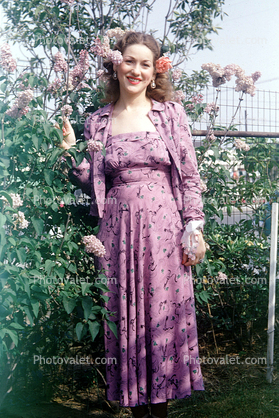 Woman in a purple formal dress, 1950s