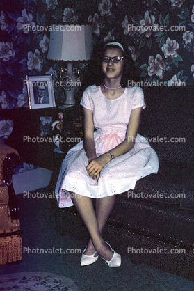 Teen Girl sitting on a Sofa, Cateye Glasses, February 1964, 1960s
