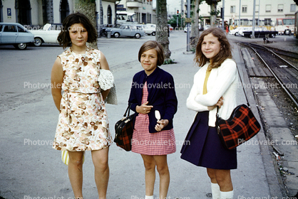 Girls, curb, sidewalk, tracks, smiles, smiling, skirts, dress, flowery, floral, 1960s