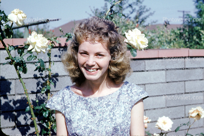 face, women, young, female, smiles, friendly, dress, roses, brick fence, 1960s