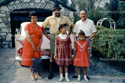 African American Family Portrait in front of a car, smiles, purse, girls, 1950s