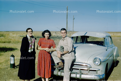 Couple in front of their car, 1940s