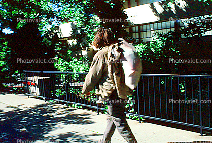 Homeless man walking, knapsack