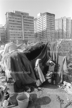 Man, baby, proud father, Shanty Home, Shack, apartment buildings, slum, Mumbai, India
