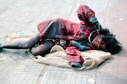 Woman Cries in Pain, laying on the sidewalk, no one cares, Mumbai, (Bombay), India