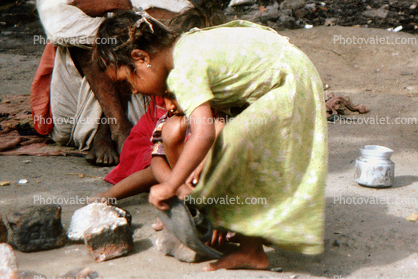 Girl playing in the squalor, slums, Mumbai, India