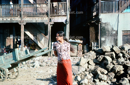 Woman Stands waiting for a bus, Slum, Mumbai, (Bombay), India