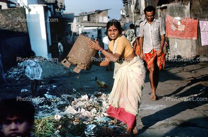 Woman dumping trash, Dharavi Mumbai