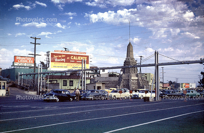 Cars, Billboards, monument, bridge, Mexican USA border, Mexico, 1950s