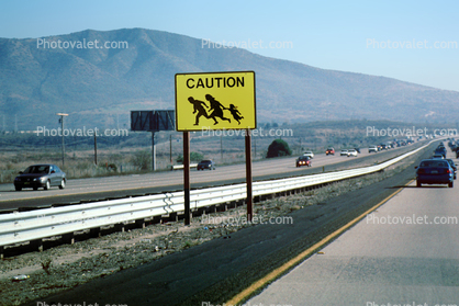 Caution Illegal Immigrant Crossing, Road sign, cars, Interstate Highway I-5, warning, Camp Pendalton, running, people