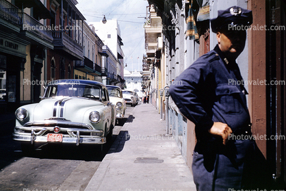 Cars, sidewalk, buildings, town, Oldsmobile, San Juan Puerto Rico, 1950s