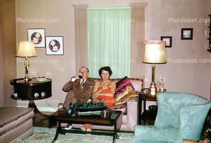 Couple Drinking, Lamps, Sofa, Curtains, Chairs, lampshade, drapes, 1950s