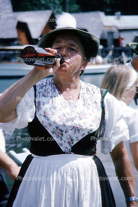 woman drinking from a bottle