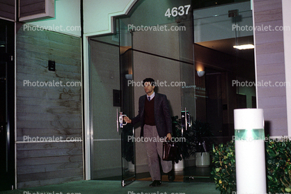 Man leaving office, evening, 1986, businessman