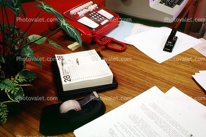 Desk, Phone, Telephone, tape dispenser, day to day calendar, paper