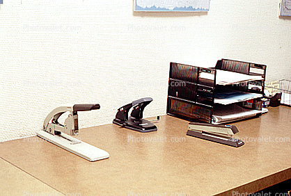 Desk, Hole Punch, Stapler, Paper Stacks, paperwork, bureaucracy, piles, archive, clutter, documents, in-out trays