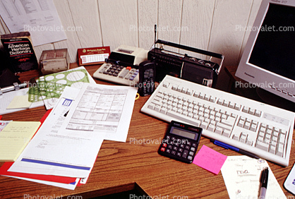 calculator, keyboard, radio, clutter, radio, cordless phone, desk, paperwork, rolodex