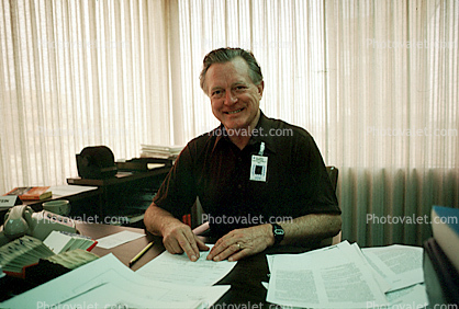 Desk, office, Man, phone, paper, paperwork, Male, Guy, Masculine, Adult, Smiles, Laugh, Laughing, 1979, businessman, 1970s