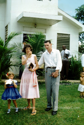 finished a church service, building, lawn, daughter, mother, father, bible, dress, sandals, the Pariers, 1950s