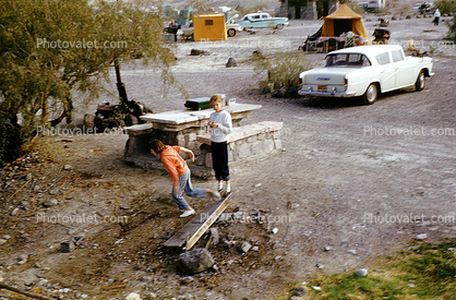 Car, Picnic Table, girls playing, tent, 1950s