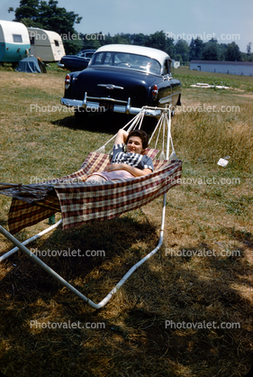 Woman relaxing on a Hammock, Chevy Belair Car, 1950s