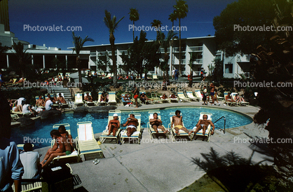 Poolside, Men, sun tanning, lounge chairs, Hotel, 1980s