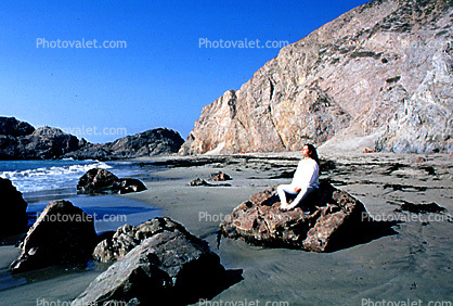 Woman Meditating at the Beach, water, rocks, sand