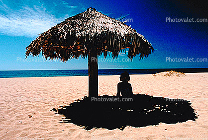 Woman on a Beach, Pacific Ocean, sand, grass thatched parasol, shade, shadow, Sod