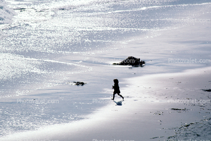 Little girl running on the beach, sand, water