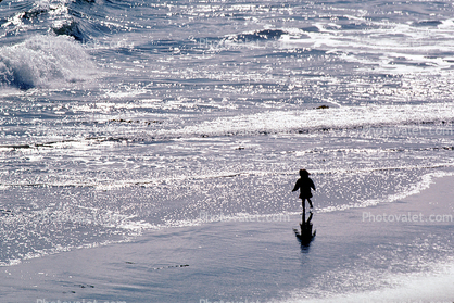 Little girl running on the beach, sand, water