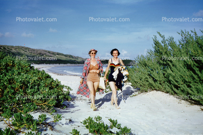 Women walking in the sand, Horseshoe Beach, Hamilton, Bermuda, 1950s
