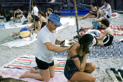 Applying sun tan lotion, Buckroe Beach, Hampton, Virginia, 1960s