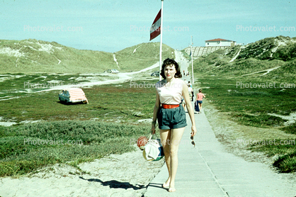 woman in shorts, walking, 1950s