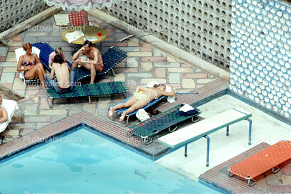 Poolside, Furniture, Patio, lounge chairs, women, men, sunning, 1973, 1970s