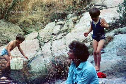 Playing by a stream, girl, boy, woman, bathingsuit, 1969, 1960s