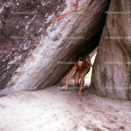 Woman, bikini, rocks, beach, tunnel, 1960s