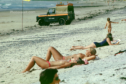 Women Sunning on the Beach, topless, 1970s