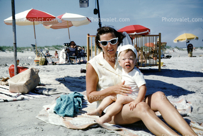 Mother, Cateye glasses, baby boy, parasol, crib, legs, woman, beach towel, 1950s