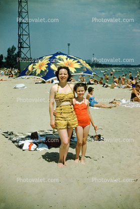 Mother with Daughter, Beach, sand, parasol, swimsuit, bathing suit, 1950s